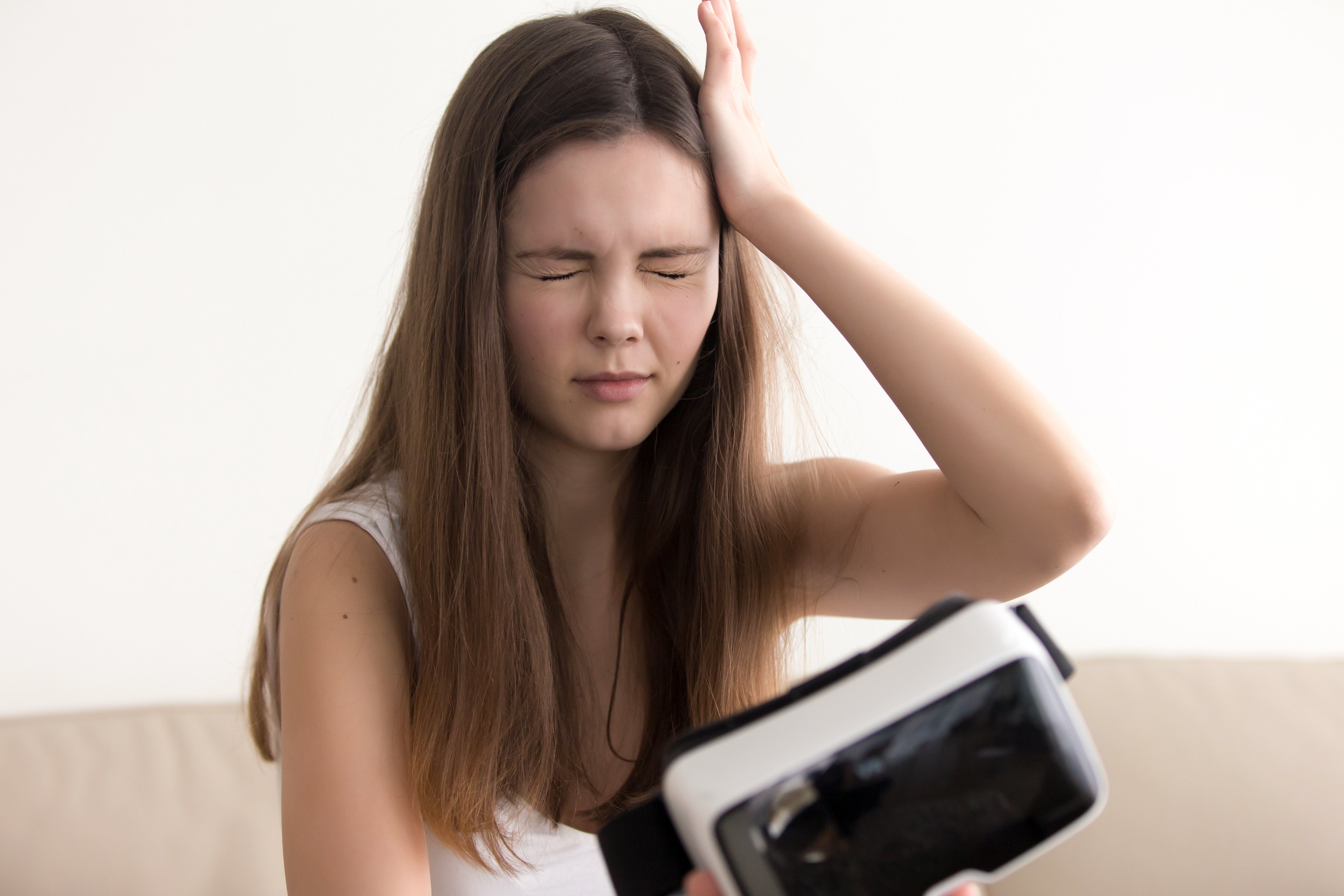 Woman experiencing VR motion sickness