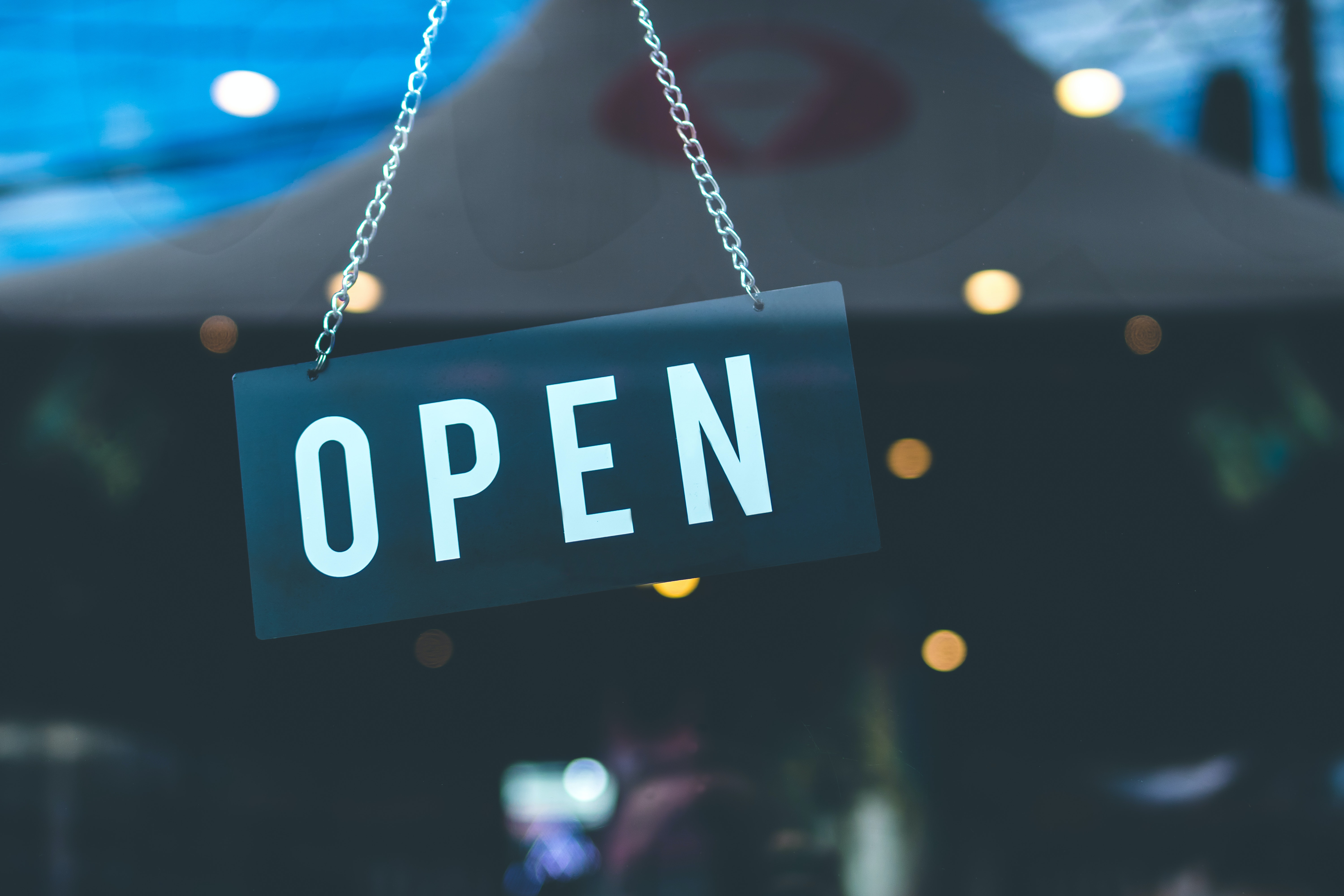 Business reopening with open sign in window